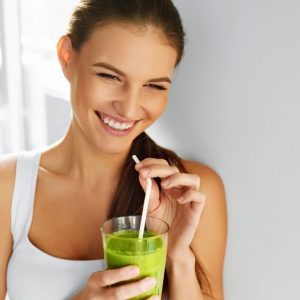 Lady drinking green juice
